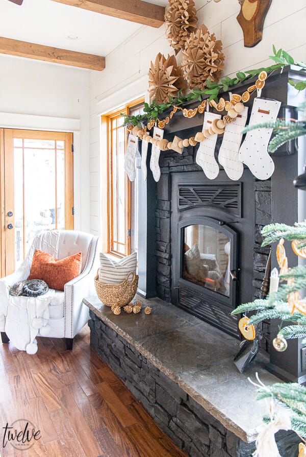How to paint a stone fireplace with a paint sprayer and give it an updated and modern look in no time! See how I gave my stacked stone fireplace a complete facelift with just a coat of paint.