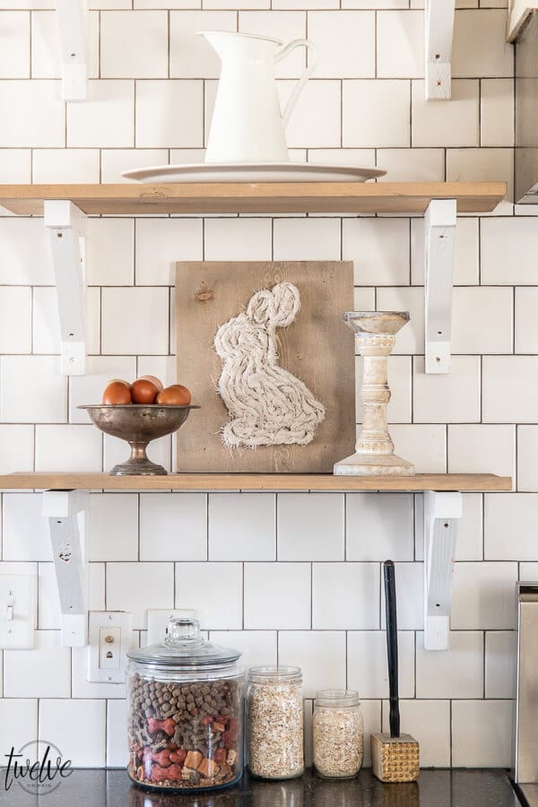 Open shelves in the kitchen, styled for spring with simple bunny art using scrap wood and scrap fabric.