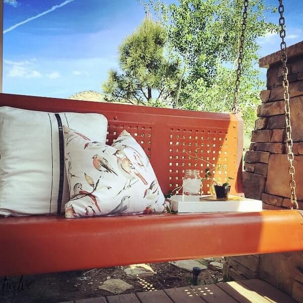 We up-cycled this old, rusted vintage metal glider into the perfect cozy porch swing perfect for relaxing on.