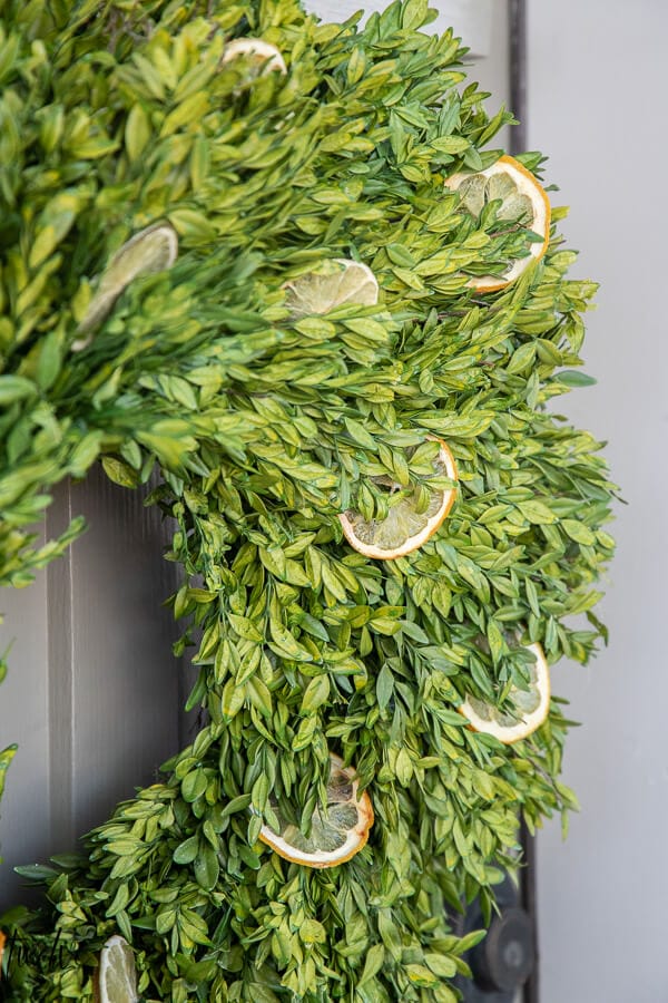 How to make a stylish boxwood and lemon summer wreath perfect for a front door or entry way.  It is easy to create and inexpensive!