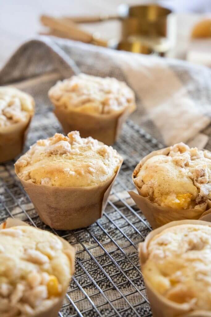 These amazing peach muffins with a cream cheese filling are the perfect way to use those peaches! Peaches and cream muffins for the win.