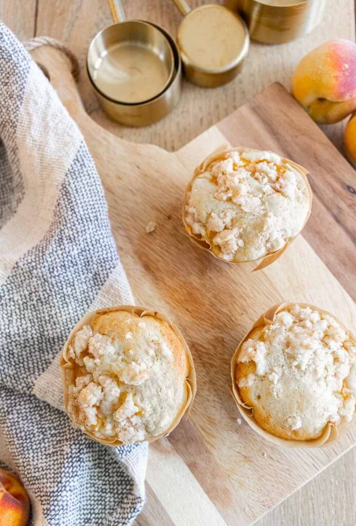 These amazing peach muffins with a cream cheese filling are the perfect way to use those peaches! Peaches and cream muffins for the win.