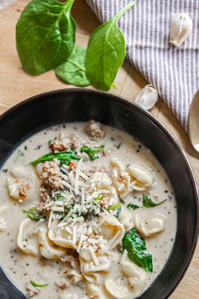 Make this creamy tortellini soup with sausage and spinach today! This is the perfect comfort food and is quick and easy to make.