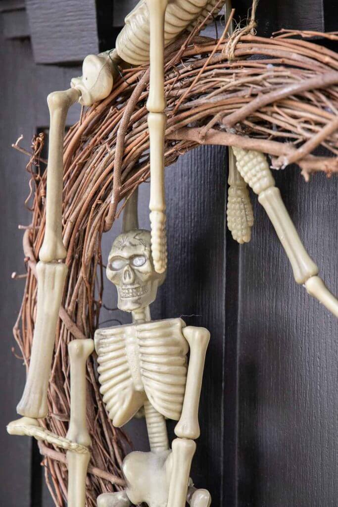 How to make a Halloween wreath using dollar store skeletons! This is a super easy Halloween wreath DIY tutorial.