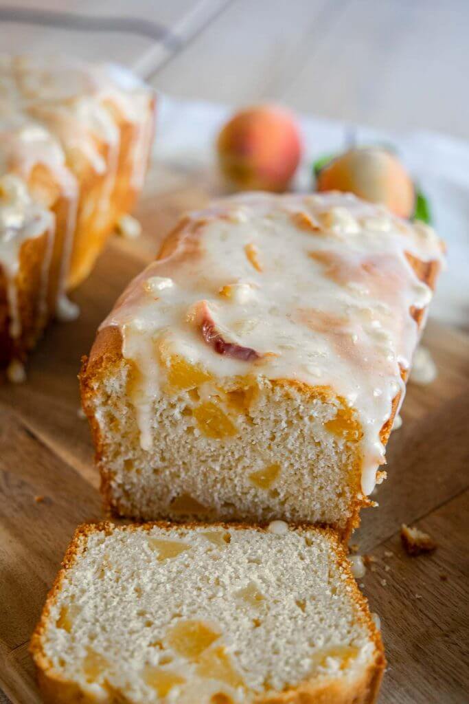 Make this amazing peach bread recipe with fresh or frozen peaches! This bread tastes amazing and has a flavorful peach glaze too! This tender and sweet bread with bite-sized peach pieces dotting the bread, its sweet, tangy and ofh so flavorful!