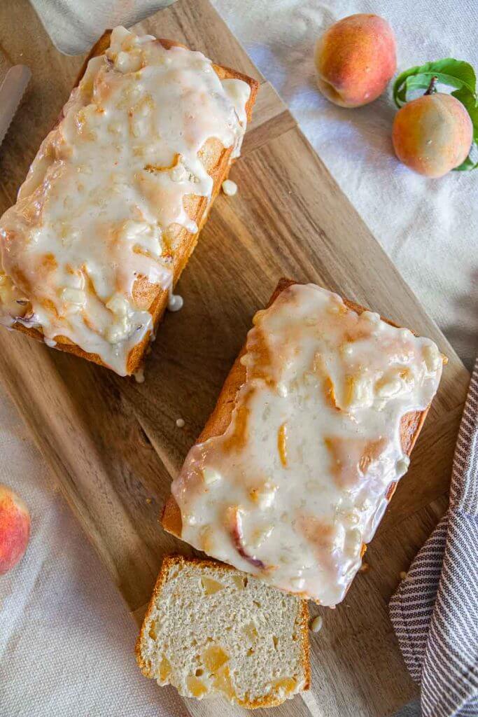 Make this amazing peach bread recipe with fresh or frozen peaches! This bread tastes amazing and has a flavorful peach glaze too! This tender and sweet bread with bite-sized peach pieces dotting the bread, its sweet, tangy and ofh so flavorful!