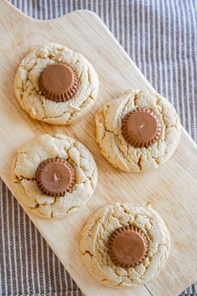 These Reese's peanut butter thumbprint cookies are so easy to make and are so good! They are perfect for any holiday!