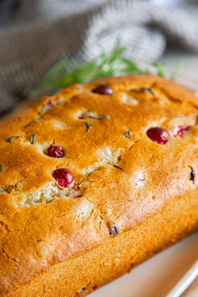 Make this amazing cranberry sweet bread with an orange rosemary glaze. This bread is sweet, tender with burst of tart cranberry. With the inclusion of orange and rosemary in the bread as well as in the glaze, this bread has an amazing flavor and texture. Make this for your next holiday get together!