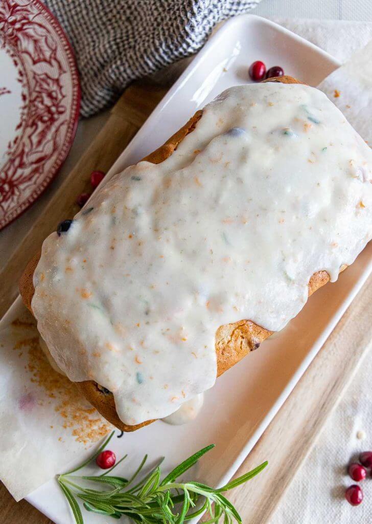 Make this amazing cranberry sweet bread with an orange rosemary glaze. This bread is sweet, tender with burst of tart cranberry. With the inclusion of orange and rosemary in the bread as well as in the glaze, this bread has an amazing flavor and texture. Make this for your next holiday get together!