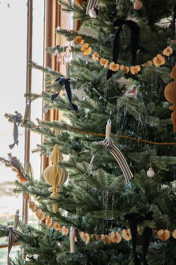 An inspiring Little Women themed Christmas tree with velvet ribbon bows, homemade garlands, dried apples, and so much more.