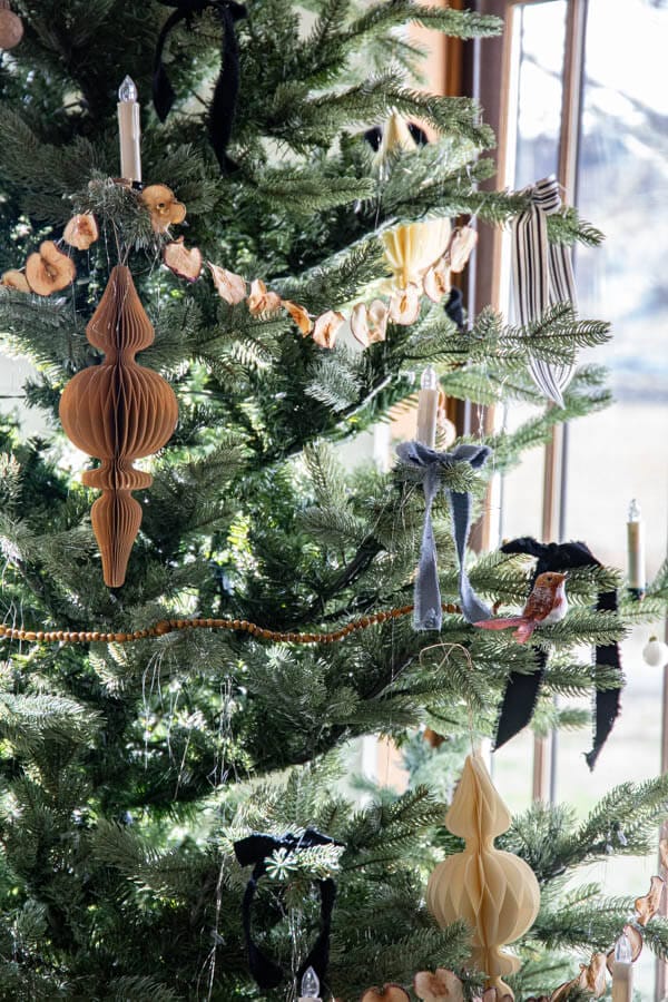 An inspiring Little Women themed Christmas tree with velvet ribbon bows, homemade garlands, dried apples, and so much more.